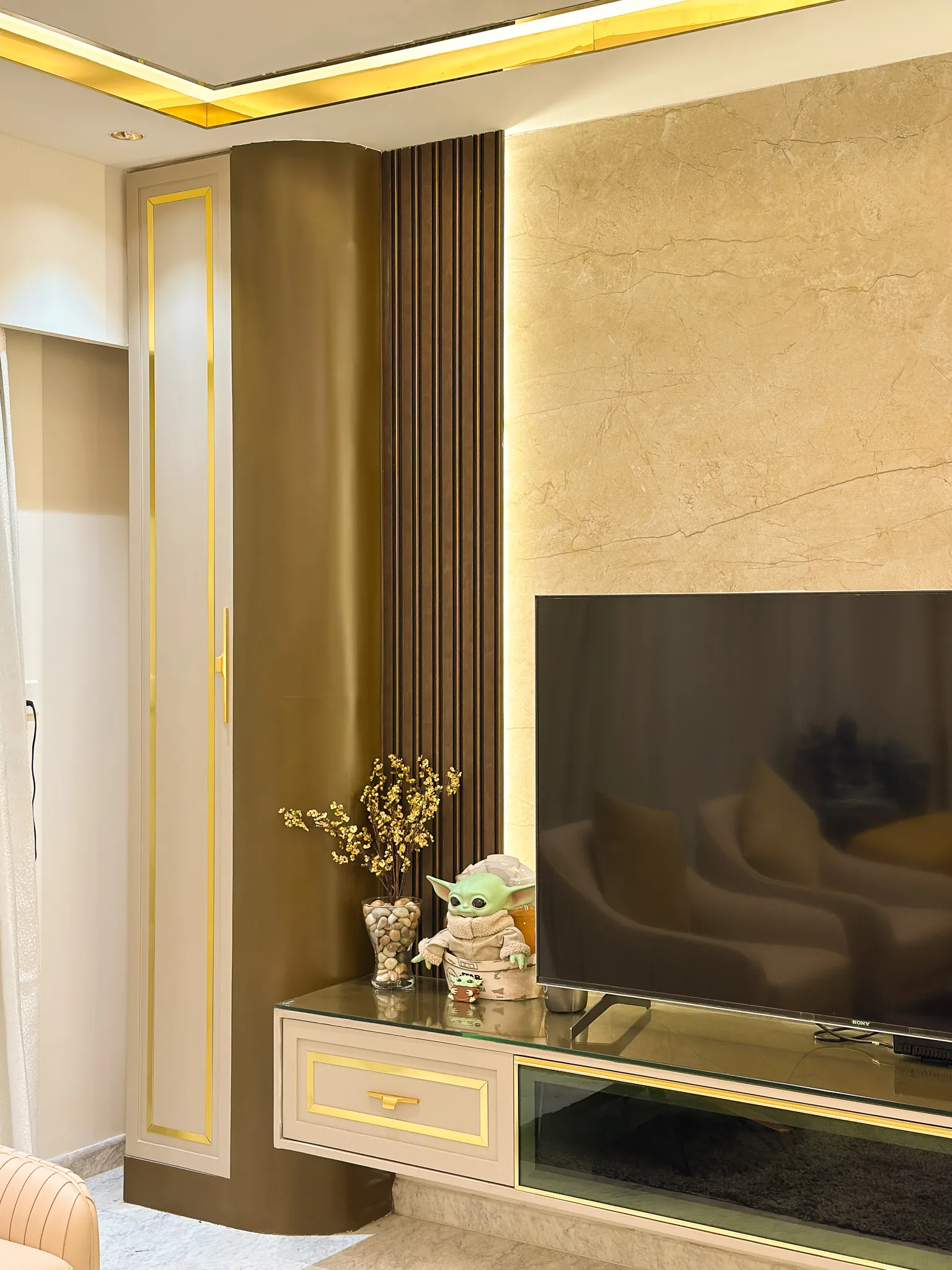Marble-clad TV wall with floating console — Divyarjuna